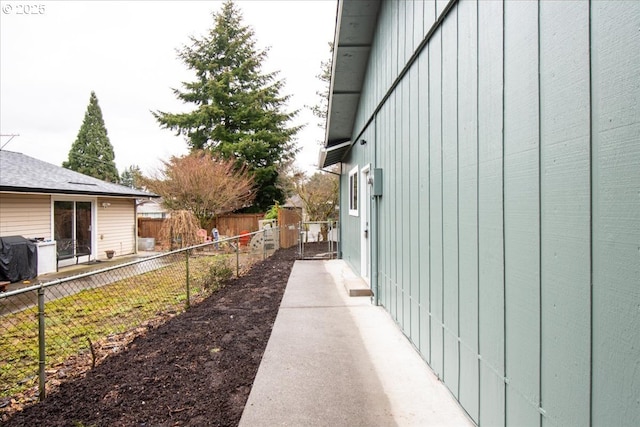 view of property exterior with fence and board and batten siding