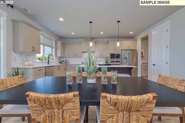 1449 NE Josephine Ct Unit 170, Estacada, OR 97023 - kitchen with stainless steel appliances, tasteful backsplash, a center island, a sink, and recessed lighting