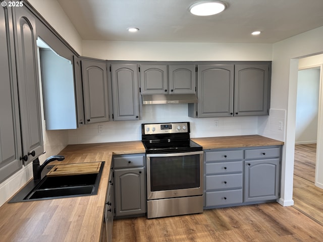 807 Glover St, Goldendale, WA 98620 - kitchen featuring stainless steel range with electric cooktop, butcher block countertops, gray cabinets, a sink, and decorative backsplash
