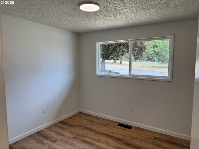 807 Glover St, Goldendale, WA 98620 - spare room featuring wood finished floors, baseboards, and a textured ceiling