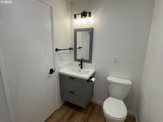 807 Glover St, Goldendale, WA 98620 - bathroom with wood finished floors, vanity, toilet, and baseboards