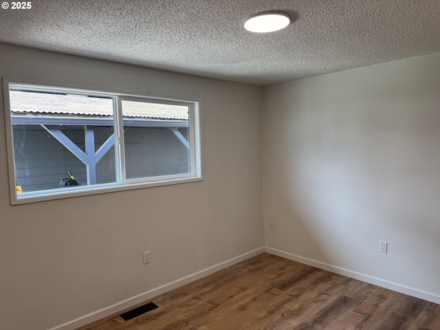 807 Glover St, Goldendale, WA 98620 - unfurnished room featuring wood finished floors, a textured ceiling, and baseboards