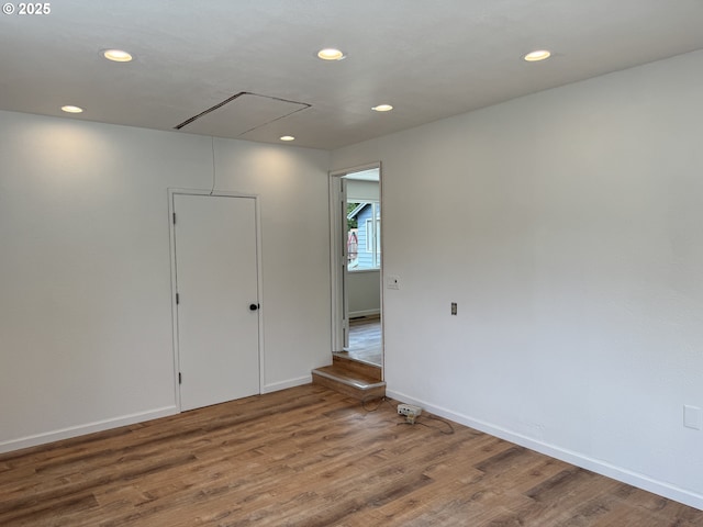 807 Glover St, Goldendale, WA 98620 - spare room with attic access, recessed lighting, wood finished floors, and baseboards
