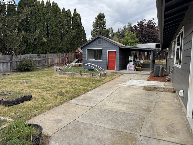 807 Glover St, Goldendale, WA 98620 - view of yard with central air condition unit, an attached carport, concrete driveway, and a playground