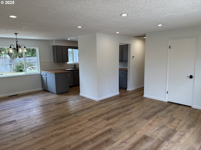 807 Glover St, Goldendale, WA 98620 - kitchen with a chandelier, recessed lighting, a textured ceiling, baseboards, and wood finished floors