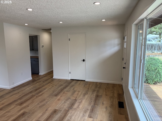 807 Glover St, Goldendale, WA 98620 - empty room featuring a textured ceiling, recessed lighting, wood finished floors, and baseboards
