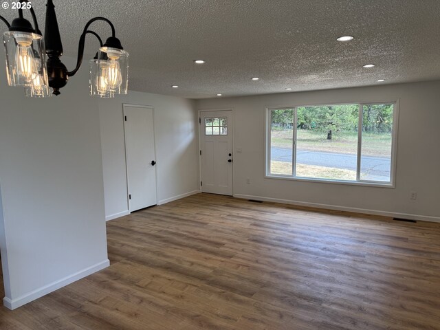 807 Glover St, Goldendale, WA 98620 - foyer featuring a chandelier, recessed lighting, a textured ceiling, wood finished floors, and baseboards