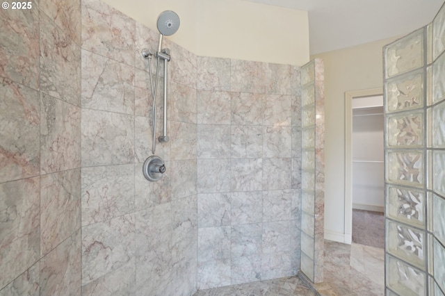 bathroom with a tile shower