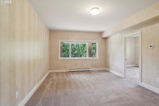 carpeted spare room featuring baseboards and a baseboard radiator