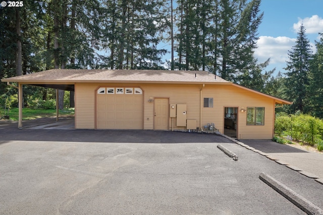 garage with aphalt driveway