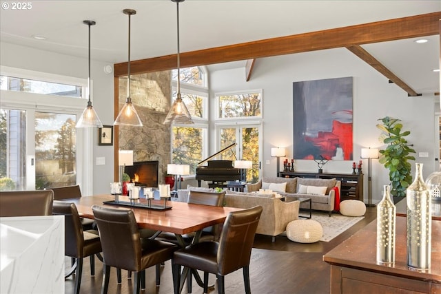 dining space featuring dark hardwood / wood-style floors, beam ceiling, and high vaulted ceiling