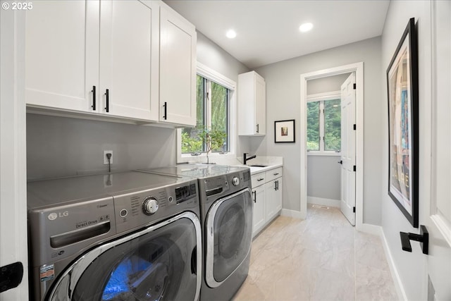 laundry room featuring cabinets, sink, a wealth of natural light, and independent washer and dryer