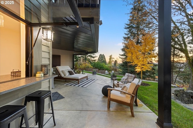 patio terrace at dusk featuring exterior bar