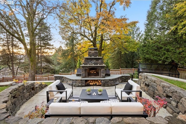 patio terrace at dusk featuring an outdoor living space with a fireplace