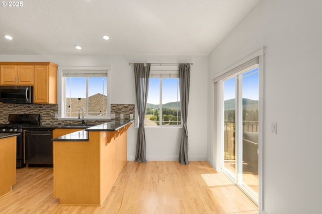 15708 SE Bybee Dr, Portland, OR 97236 - kitchen with black gas stove, plenty of natural light, dishwashing machine, a mountain view, and recessed lighting