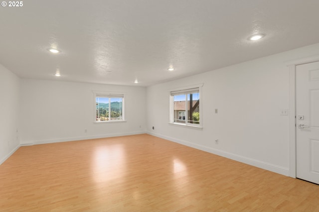 15708 SE Bybee Dr, Portland, OR 97236 - unfurnished room with light wood-type flooring, plenty of natural light, and recessed lighting