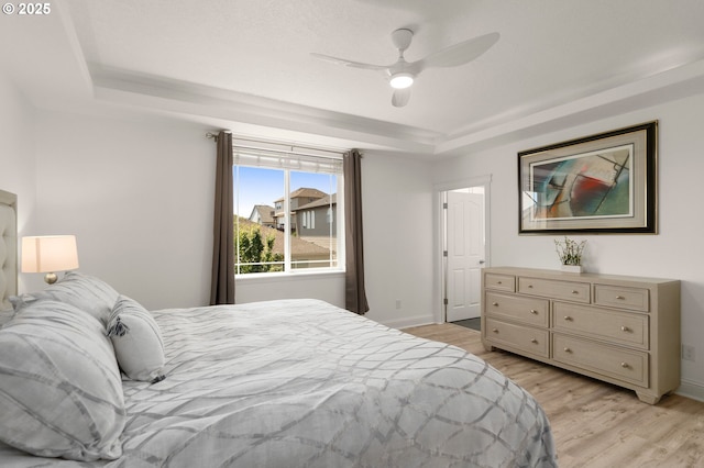 15708 SE Bybee Dr, Portland, OR 97236 - bedroom featuring a raised ceiling, light wood finished floors, and ceiling fan