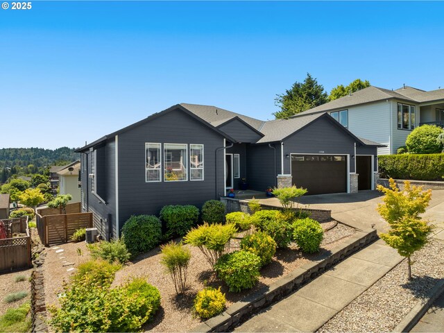 15708 SE Bybee Dr, Portland, OR 97236 - view of front facade featuring concrete driveway and a garage