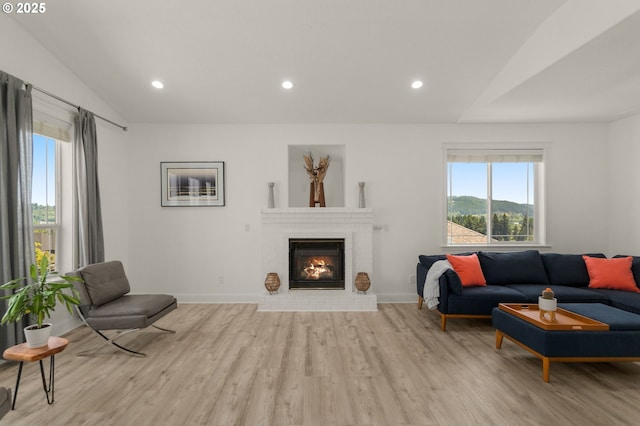 15708 SE Bybee Dr, Portland, OR 97236 - living room with wood finished floors, vaulted ceiling, a brick fireplace, and recessed lighting