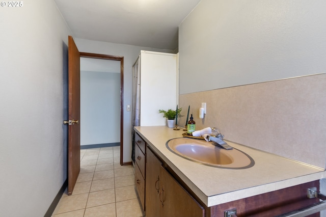 bathroom featuring vanity, baseboards, and tile patterned floors