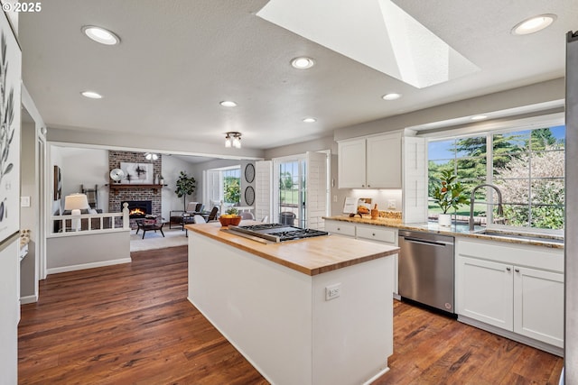 209 Mcnary Estates Dr N, Keizer, OR 97303 - kitchen featuring butcher block counters, stainless steel appliances, a fireplace, recessed lighting, and dark wood finished floors