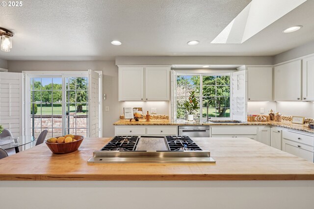 209 Mcnary Estates Dr N, Keizer, OR 97303 - kitchen featuring appliances with stainless steel finishes, butcher block countertops, white cabinets, healthy amount of natural light, and recessed lighting