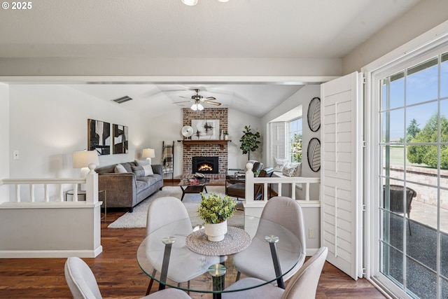 209 Mcnary Estates Dr N, Keizer, OR 97303 - dining space featuring vaulted ceiling, ceiling fan, wood finished floors, and a fireplace