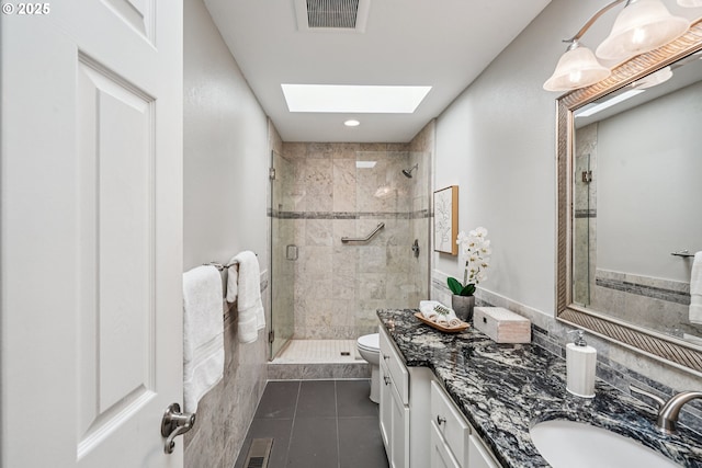 209 Mcnary Estates Dr N, Keizer, OR 97303 - bathroom with a stall shower, a skylight, tile patterned floors, and vanity