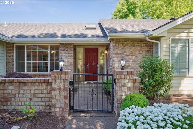 209 Mcnary Estates Dr N, Keizer, OR 97303 - doorway to property featuring a gate, brick siding, and roof with shingles