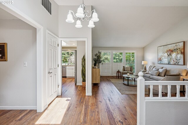 209 Mcnary Estates Dr N, Keizer, OR 97303 - living room with wood-type flooring, a chandelier, and vaulted ceiling