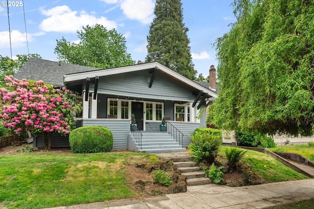 2522 NE 50th Ave, Portland, OR 97213 - bungalow-style house featuring covered porch, a front yard, a shingled roof, and stairs