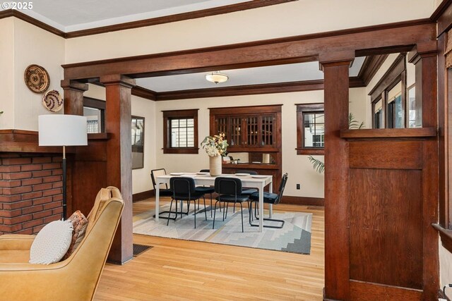 2522 NE 50th Ave, Portland, OR 97213 - dining room featuring wood finished floors, baseboards, decorative columns, and crown molding