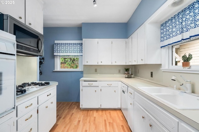 2522 NE 50th Ave, Portland, OR 97213 - kitchen featuring white appliances, a sink, white cabinetry, and light countertops