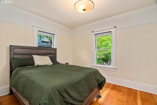 2522 NE 50th Ave, Portland, OR 97213 - bedroom with baseboards, multiple windows, and wood finished floors