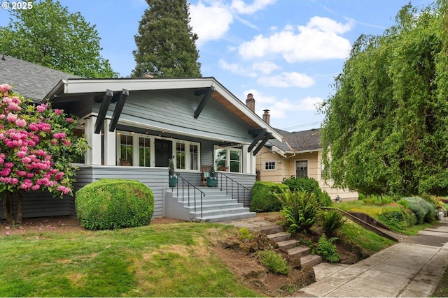 2522 NE 50th Ave, Portland, OR 97213 - bungalow-style home featuring covered porch, a chimney, a front lawn, and a shingled roof