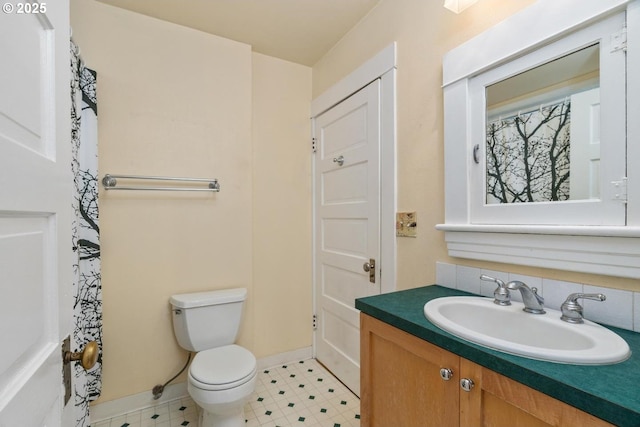 2522 NE 50th Ave, Portland, OR 97213 - full bathroom with toilet, vanity, tile patterned floors, and baseboards