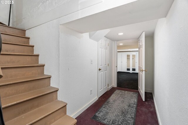 2522 NE 50th Ave, Portland, OR 97213 - stairway with baseboards, finished concrete floors, recessed lighting, and a textured wall
