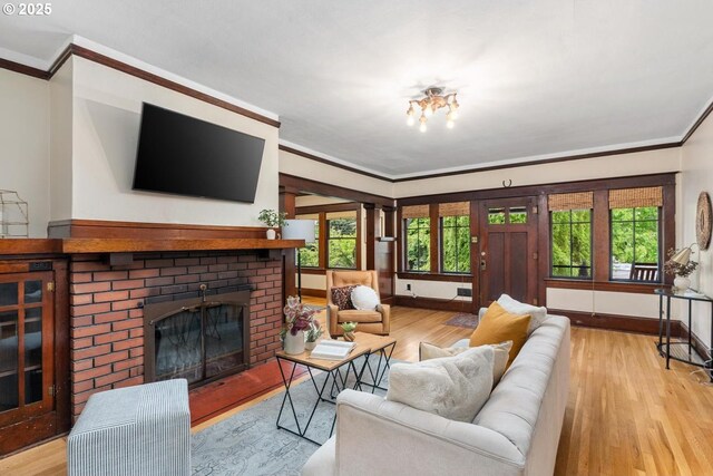 2522 NE 50th Ave, Portland, OR 97213 - living area with ornamental molding, wood finished floors, a fireplace, baseboards, and plenty of natural light
