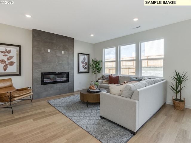 239 NW 29th Way, Battle Ground, WA 98604 - living room with baseboards, recessed lighting, light wood finished floors, and a fireplace