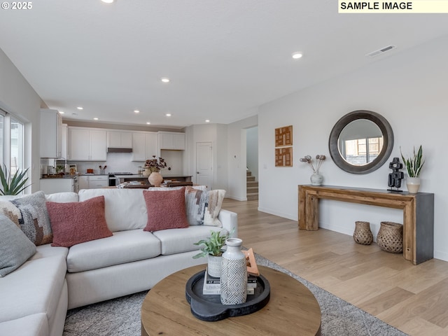 239 NW 29th Way, Battle Ground, WA 98604 - living area featuring visible vents, stairs, baseboards, light wood-style floors, and recessed lighting