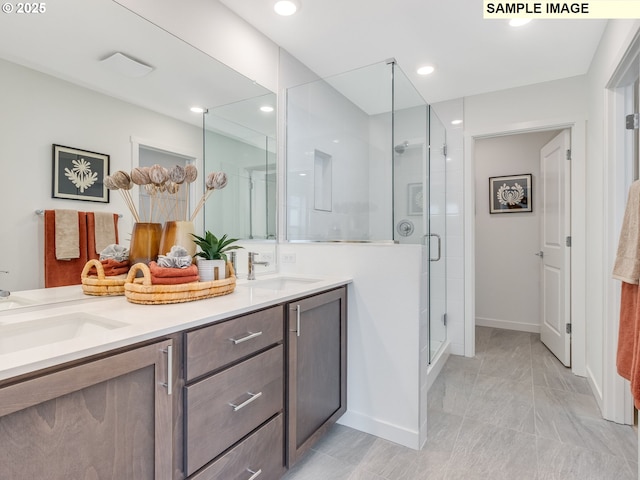 239 NW 29th Way, Battle Ground, WA 98604 - bathroom featuring double vanity, a stall shower, a sink, baseboards, and recessed lighting
