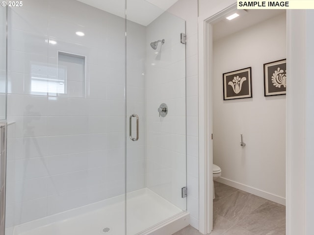 239 NW 29th Way, Battle Ground, WA 98604 - bathroom featuring toilet, baseboards, a shower stall, and marble finish floor
