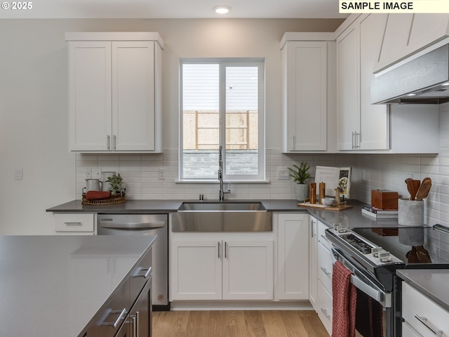 239 NW 29th Way, Battle Ground, WA 98604 - kitchen with white cabinets, stainless steel appliances, decorative backsplash, and a sink