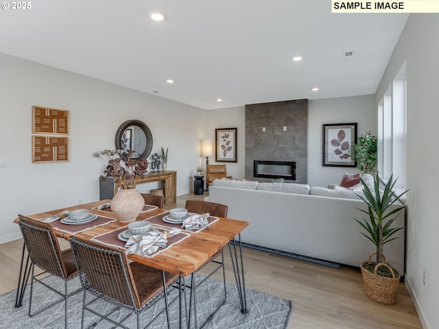 239 NW 29th Way, Battle Ground, WA 98604 - dining area featuring light wood-style floors, recessed lighting, and a tile fireplace