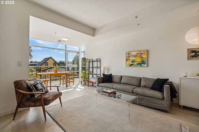 living area with expansive windows and wood finished floors