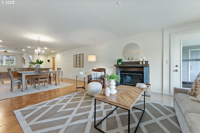6708 N Richmond Ave, Portland, OR 97203 - living area with recessed lighting, baseboards, a glass covered fireplace, and a notable chandelier