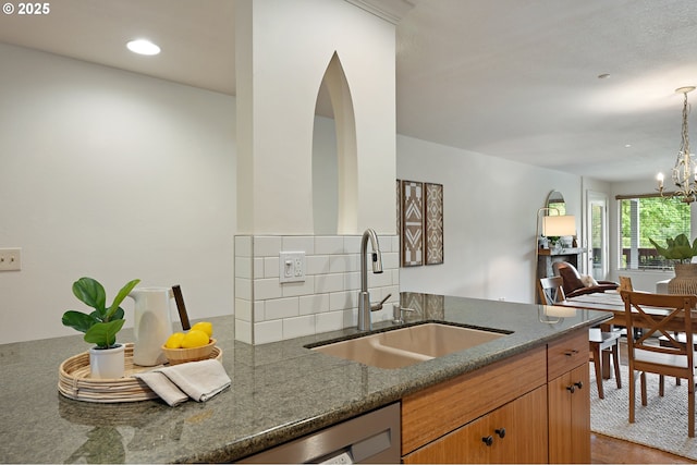 6708 N Richmond Ave, Portland, OR 97203 - kitchen with a sink, open floor plan, an inviting chandelier, dark stone counters, and recessed lighting