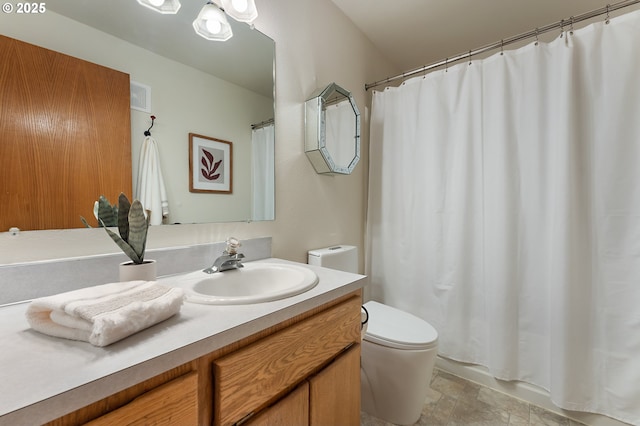 6708 N Richmond Ave, Portland, OR 97203 - bathroom with vanity, toilet, stone finish flooring, curtained shower, and visible vents