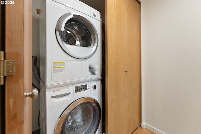 6708 N Richmond Ave, Portland, OR 97203 - laundry area featuring baseboards, stacked washer / drying machine, and laundry area