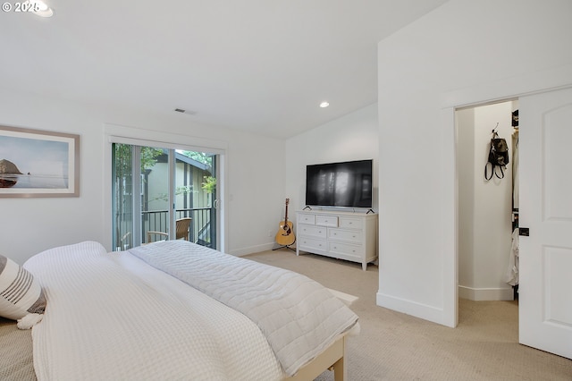 carpeted bedroom featuring lofted ceiling and access to exterior